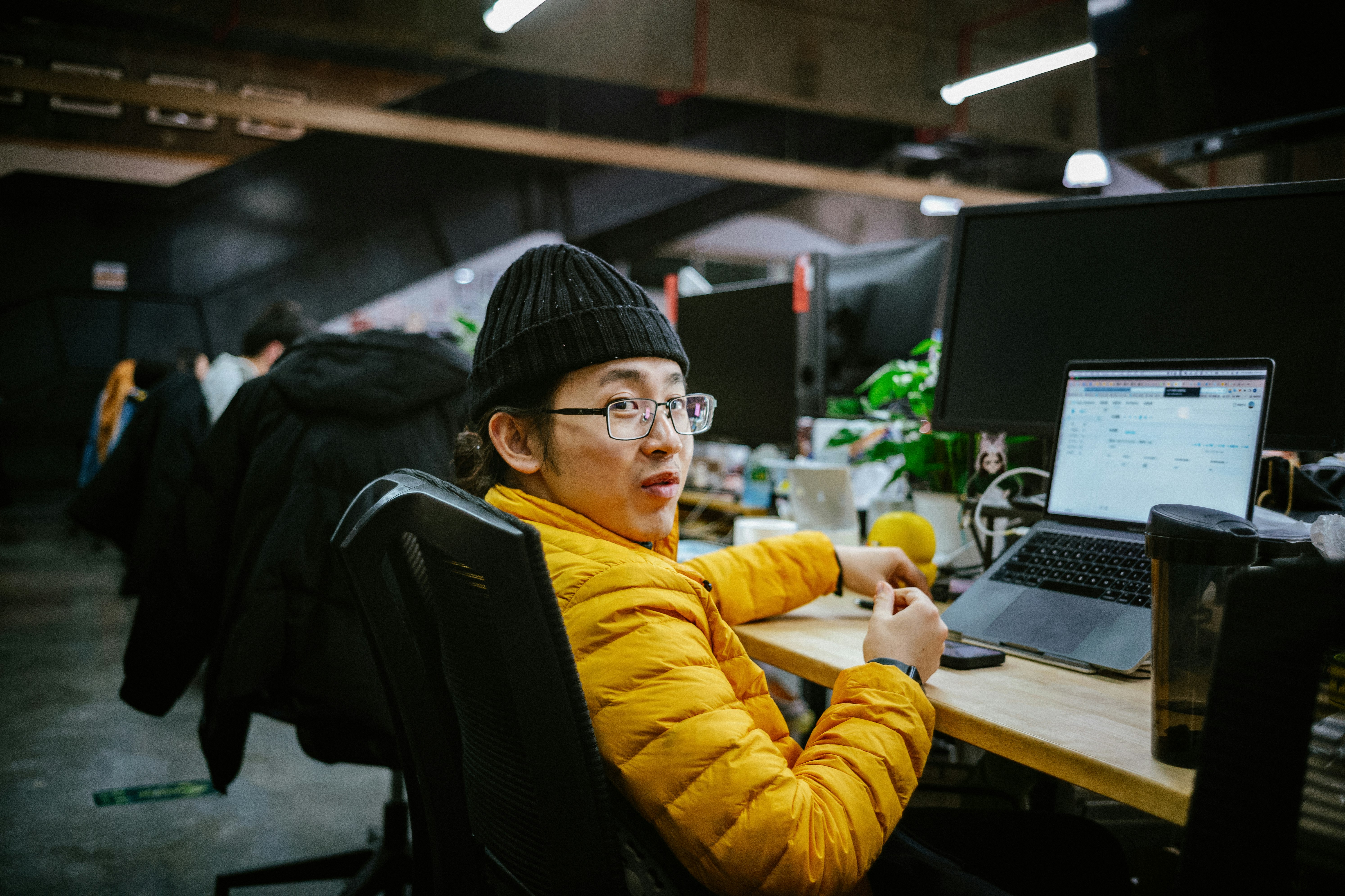 a man sitting at a desk in front of a computer